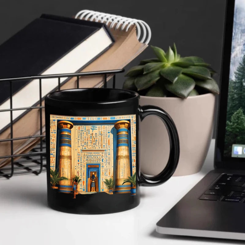 A black Egyptian temple designed ceramic cup with hieroglyphics and columns is suitable for drinking coffee, tea, or water at ho